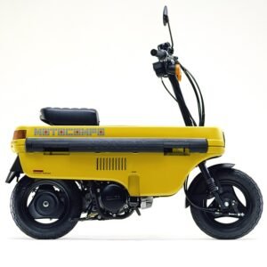 Side view of a bright yellow Honda Motocompo folding scooter with black wheels, seat, handlebars, and compact engine, isolated on white.