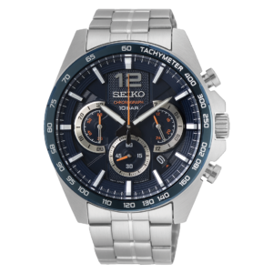 A polished silver Seiko chronograph watch with a dark blue tachymeter dial, three subdials, and a metal link bracelet, shown against black. Its precise, sporty design feels refined and technical.