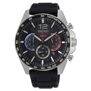 A Seiko chronograph wristwatch with a black dial, three subdials, silver tachymeter bezel, and black rubber strap, shown on a dark background.
